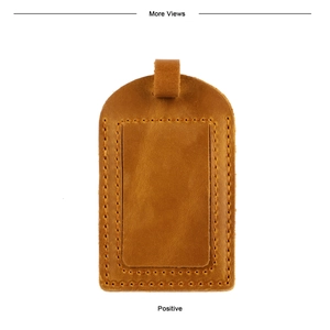 Close-up of brown crazy horse leather luggage tag with precision stitching and ID window