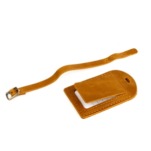 Detail of crazy horse leather luggage tag with privacy flap and adjustable metal buckle strap