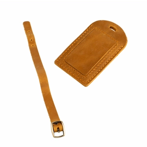 Detail of crazy horse leather luggage tag with fine stitching and adjustable metal buckle strap