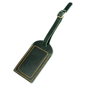 Detail of dark green leather luggage tag with contrast orange stitching and metal buckle