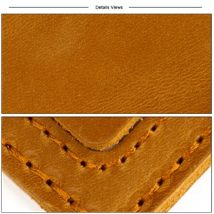 Close-up of crazy horse leather texture and orange reinforced stitching on luggage tag