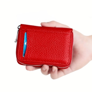 Close-up of red pebbled leather RFID wallet showing card slot and silver zipper detail