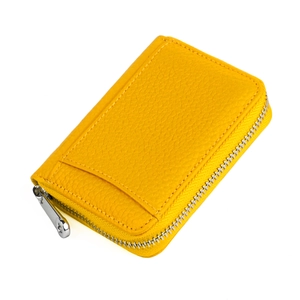Close-up of yellow pebbled leather wallet with silver zipper and fine hand-stitched detail