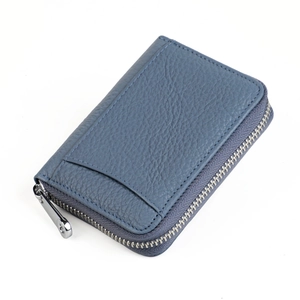Detail of blue pebble grain leather wallet showing card slot and metal zipper puller