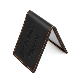 Detail of vintage crazy horse leather driving license cover with orange stitching
