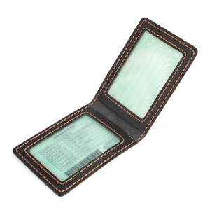 Detail of vintage leather driver's license holder with orange stitching and dual clear windows