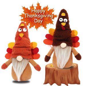 Pair of Thanksgiving turkey gnomes plush with orange hats and white beards on white background
