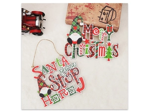 Macro detail of plaid Merry Christmas and Santa Stop Here wooden tree hanging ornaments