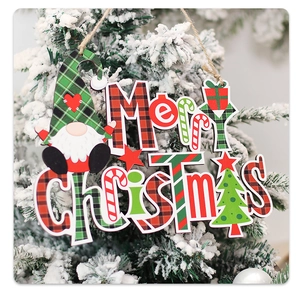 Macro detail of Merry Christmas wooden gnome ornament hanging on a snowy tree branch