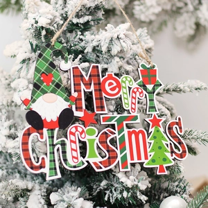Merry Christmas wooden sign with red green plaid gnomes hanging on a snowy Xmas tree