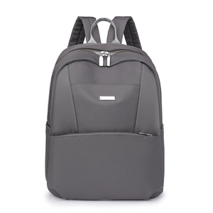 Detail of dark grey travel backpack with dual zippers and durable nylon texture