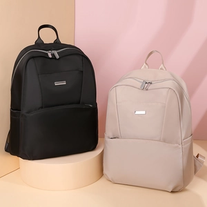 Detail of minimalist waterproof nylon backpacks in black and beige for women