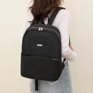 Minimalist black waterproof laptop backpack with silver zippers and large front pocket
