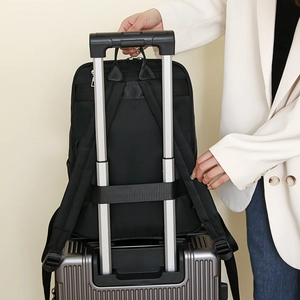 Detail of black travel backpack with trolley strap fixed on luggage handle