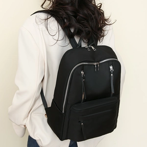 Stylish black nylon backpack with multiple zipper pockets shown at a 45-degree angle