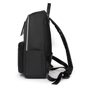 Side view of black large capacity travel backpack with silver metal zippers and wide straps