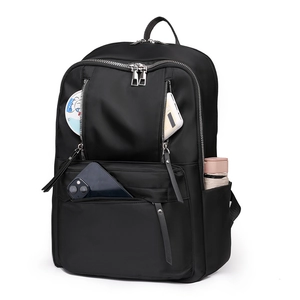 Detail view of large capacity black backpack showing multiple zippers and side storage pockets