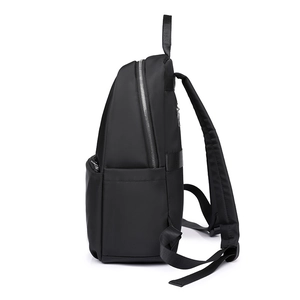 Detail view of durable black nylon backpack with metal zipper and reinforced straps