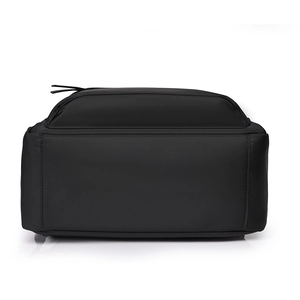 Detailed view of the durable matte black nylon backpack base with reinforced stitching