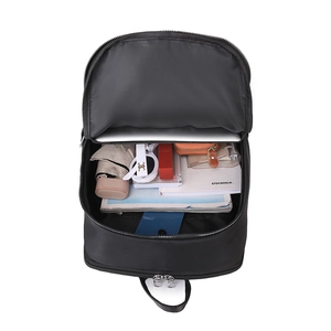 Top view of spacious black travel backpack interior with laptop and travel essentials