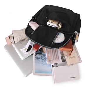 Detailed top view of large capacity black nylon backpack showing organized interior storage