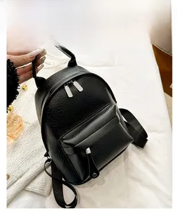 Detail showing mini black pebbled PU leather backpack with adjustable nylon straps