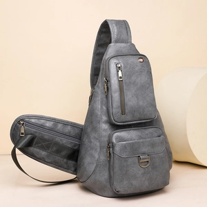 Detail view of grey vintage textured leather crossbody bag with multiple zip compartments
