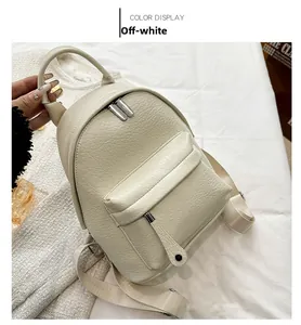 Detail of cream white mini backpack in lychee texture PU leather with front zipper pocket