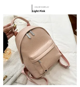 Detail view of light pink soft PU leather backpack with fine lychee texture and zippers