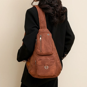Detailed back view of brown vintage leather crossbody bag with multiple zip pockets