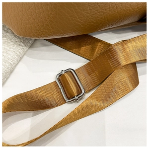Détail d'un sac en cuir PU marron grainé avec bandoulière réglable en nylon