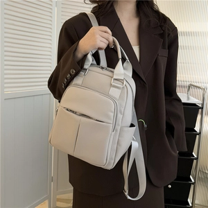 Women's chic beige lychee grain PU leather backpack with silver zippers and webbing strap