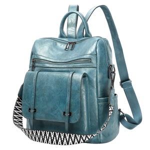 Macro view of teal blue PU leather backpack with vintage texture and woven strap