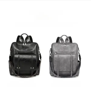 Detail view of vintage PU leather backpacks in black and gray with woven shoulder straps
