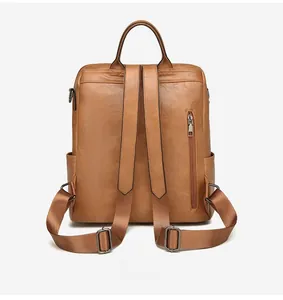 Detail view of the brown PU leather backpack back with anti-theft zipper pocket