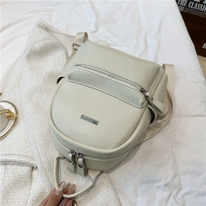 Close-up of litchi-patterned PU leather backpack with metallic zippers and hardware