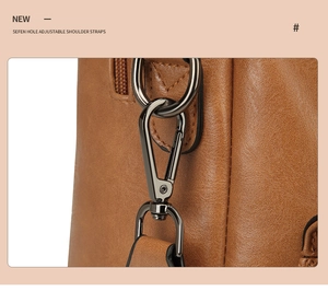 Detail view of adjustable strap with gunmetal hook and D-ring on brown leather backpack