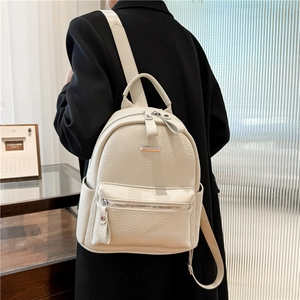 Modern beige PU leather backpack shown on female model for stylish daily commuting