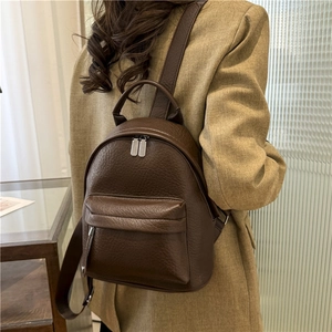 Chic dark brown pebbled PU leather mini backpack for women, shown on a model's back