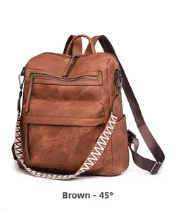 Detailed side view of vintage brown leather backpack with patterned woven shoulder strap