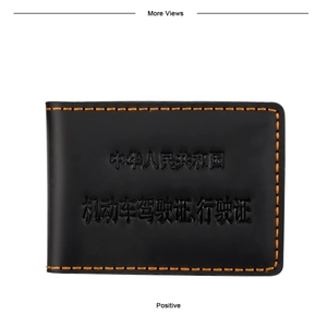 Detail of black leather driver's license holder with yellow stitching and embossed logo