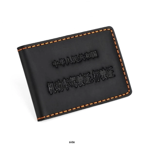 Detailed view of black crazy horse leather driver license cover with orange hand-stitching
