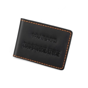 Detail of vintage black leather driver license case with high-contrast orange hand stitching