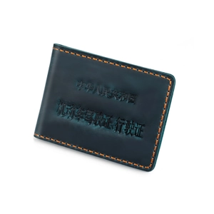Close-up of blue crazy horse leather driver license cover with orange hand-stitching