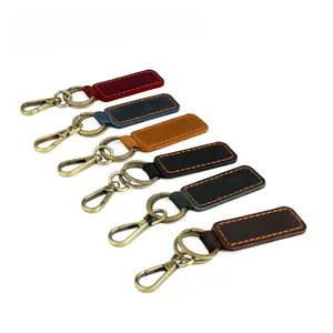 Detail of handmade crazy horse leather keychains in six vintage colors with brass metal clips