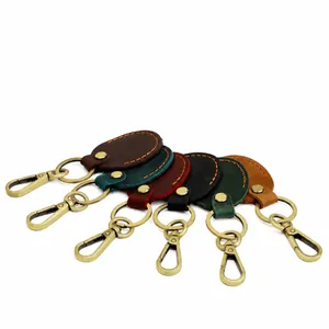 Detail view of leather keychains in six colors with gold lobster clasps and orange stitching