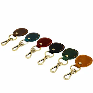 Detailed view of leather keychains in six colors with vintage brass hardware clips