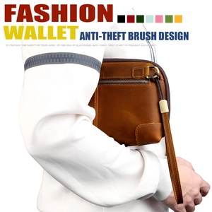 Detail of vintage leather clutch bag featuring anti-theft design and wrist strap