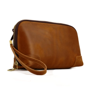 Detailed view of vintage brown crazy horse leather clutch bag with a durable wrist strap