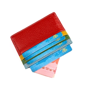 Close-up of red genuine leather card holder featuring multi-color slots and stitching